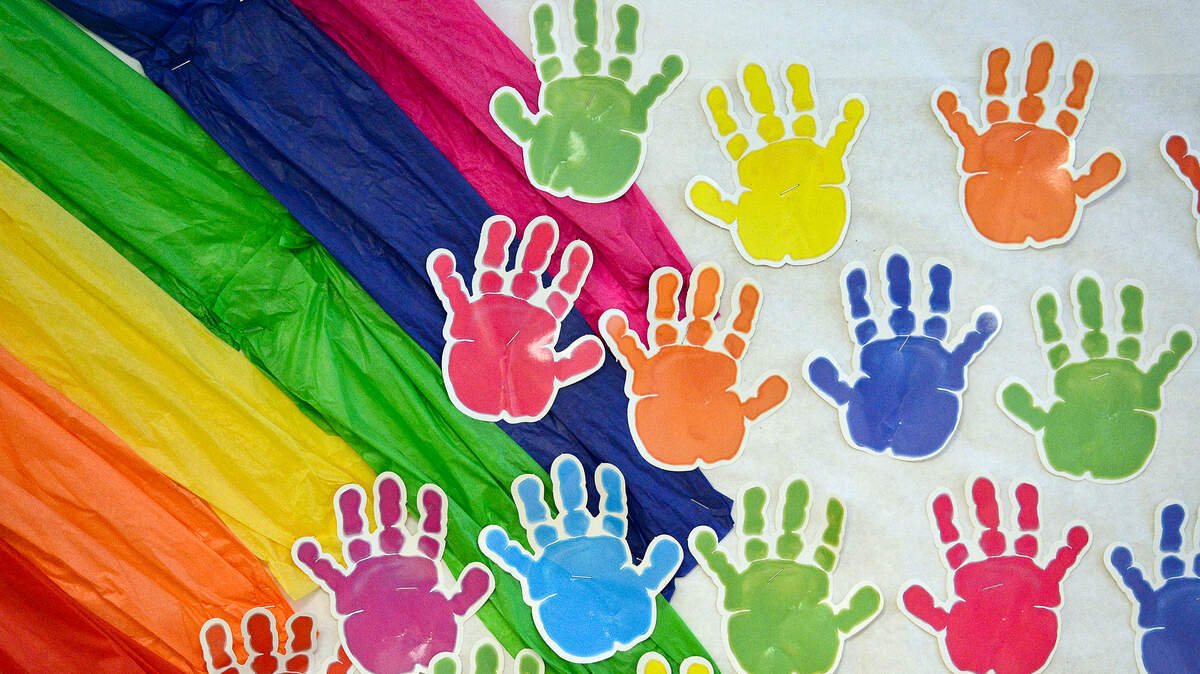 Student hand prints and a rainbow cover a wall in the classroom at a preschool in Fresno County. The city of Fresno recently established a commission on child care.